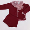 Maroon baby outfit with lace details and a bow on a white background